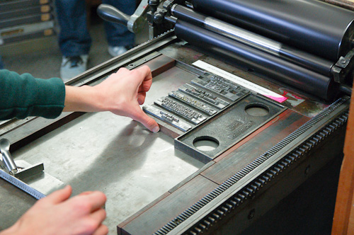 Putting lines of type onto the bed of the press