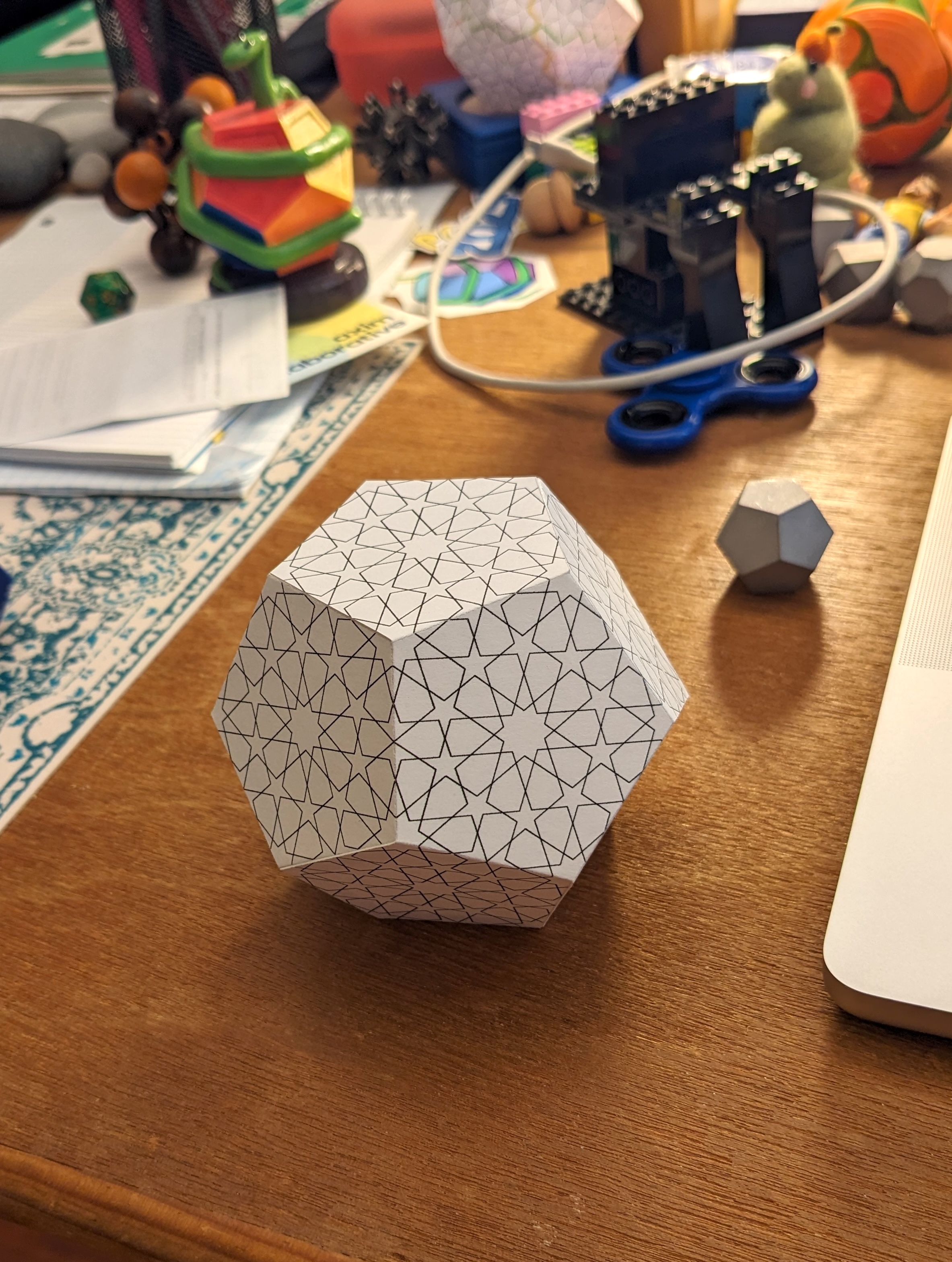A paper dodecahedron on a cluttered desk